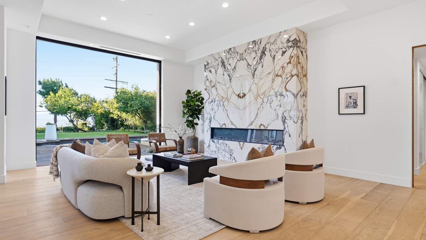 Formal living room with book-matched marble fireplace